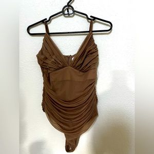 Arita is Babaton beige mesh bodysuit